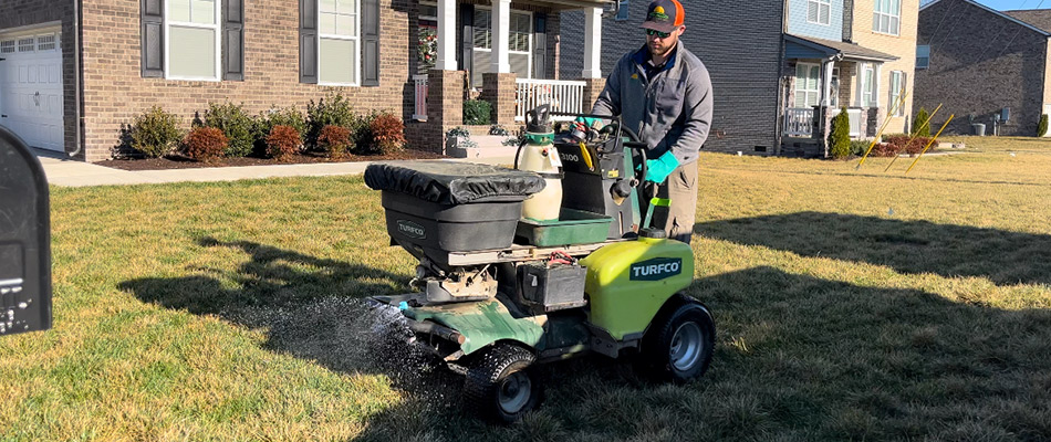 A professional technician fertilizing a lawn in Nashville, TN.