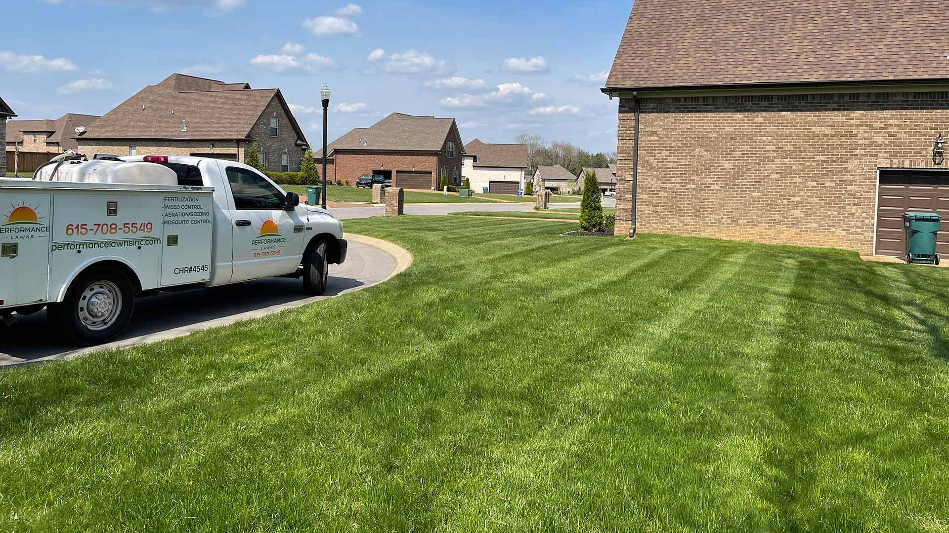 Performance Lawns Inc. work truck next to a healthy lawn in Gallatin, TN.