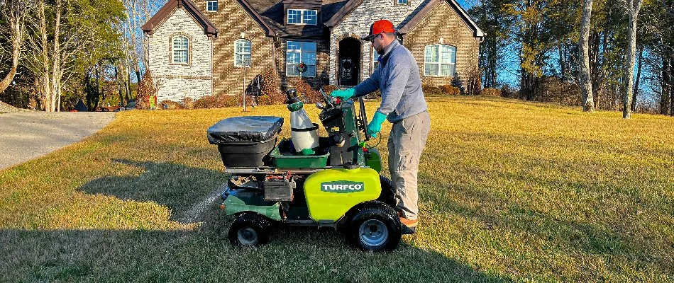 Lawn care professional spreading fertilizer in Gallatin, TN.