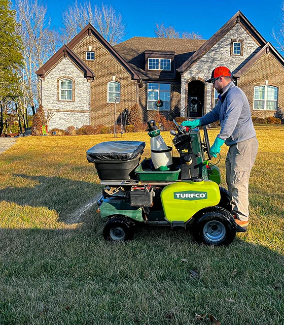 A professional servicing a lawn in Nashville, TN.